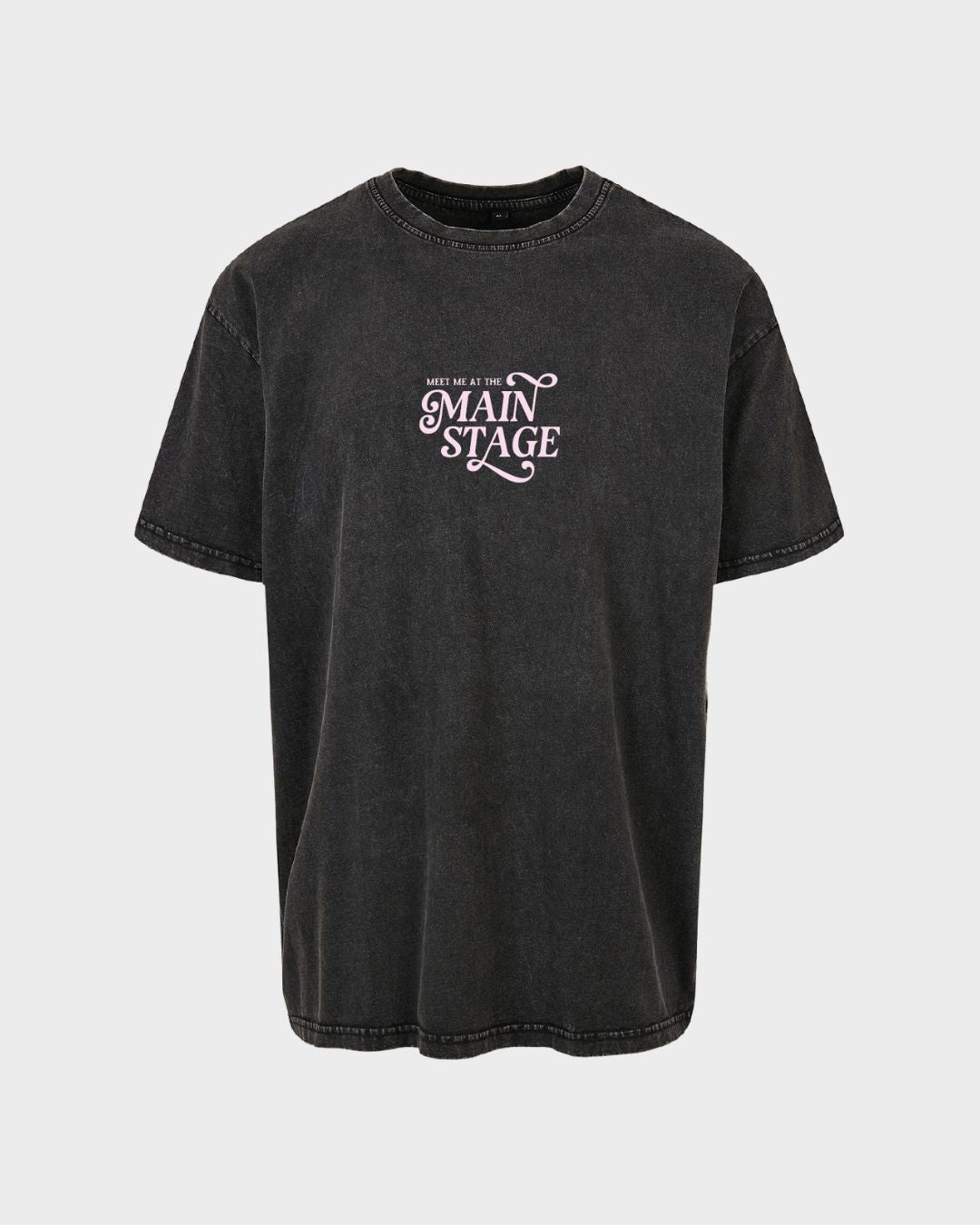 The Main Stage Acid Wash T-Shirt by 2025 is a faded black tee with white stitching, featuring MEET ME AT THE MAIN STAGE in white and pink font on the front center, shown against a plain light background.